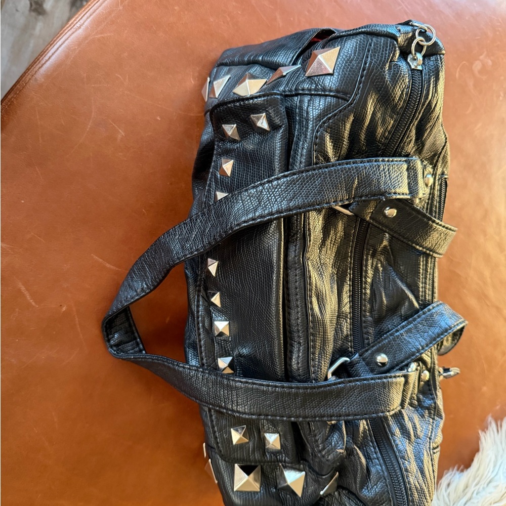 Studded barrel handbag with red lining